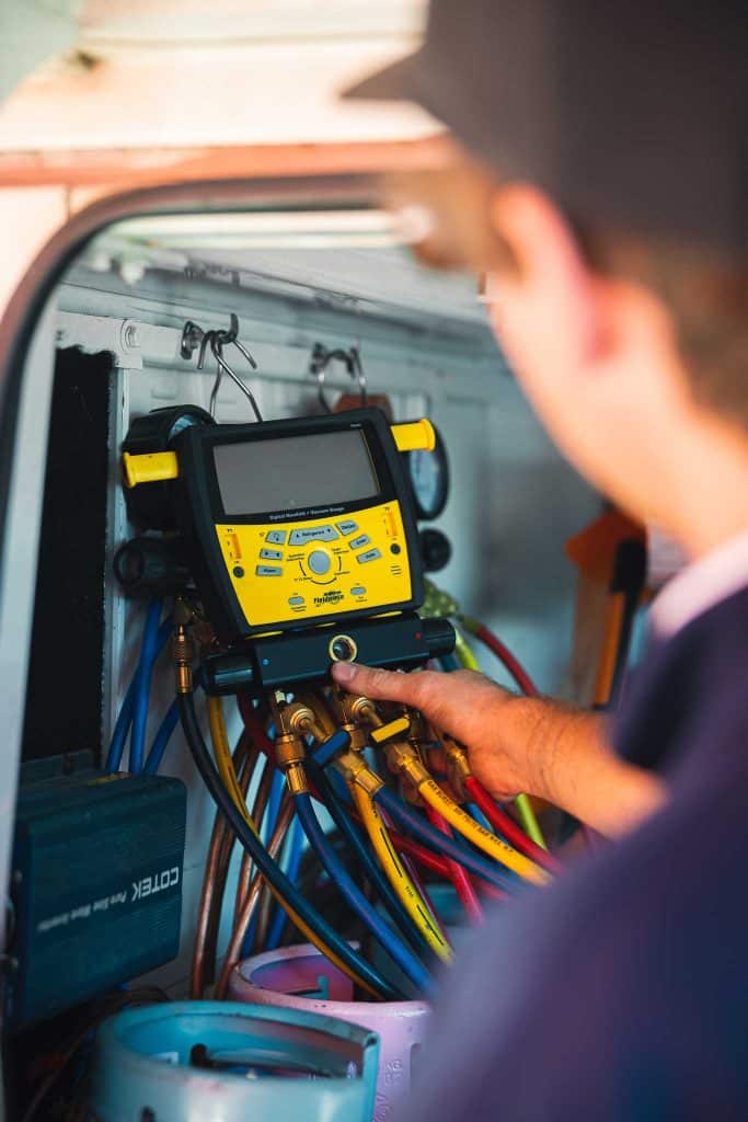Worker calibrating a machine