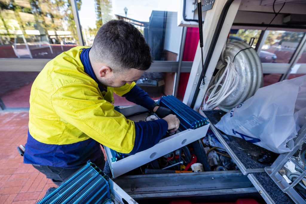 Electrician installing air conditioner equipment