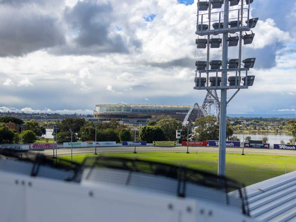 Air conditioner unit in the foreground fo a photo of a stadium