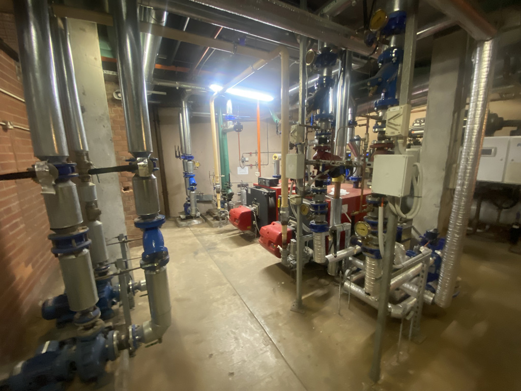 A basement filled with machinery and pipes