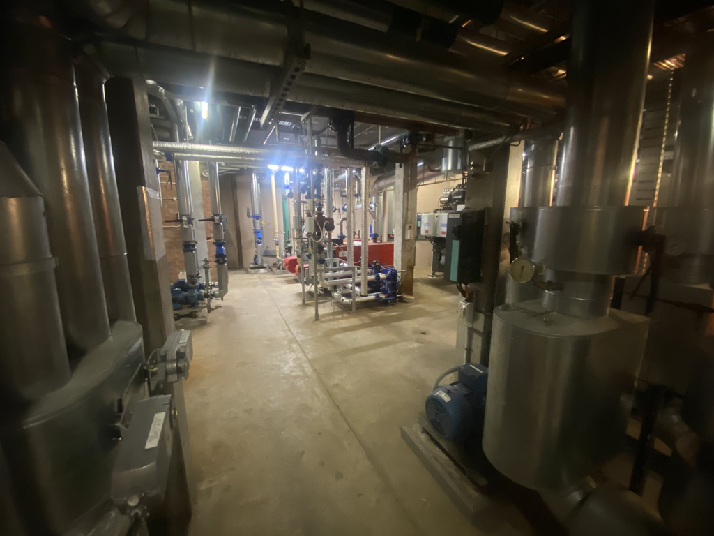 A basement filled with machinery and pipes
