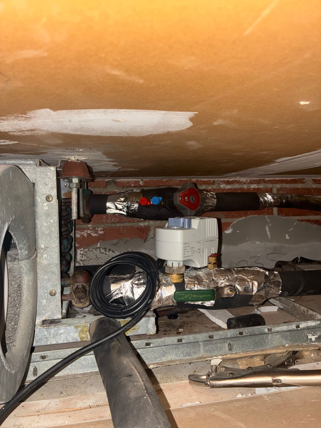 Newly installed motorised valve and pipework inside an HVAC system.