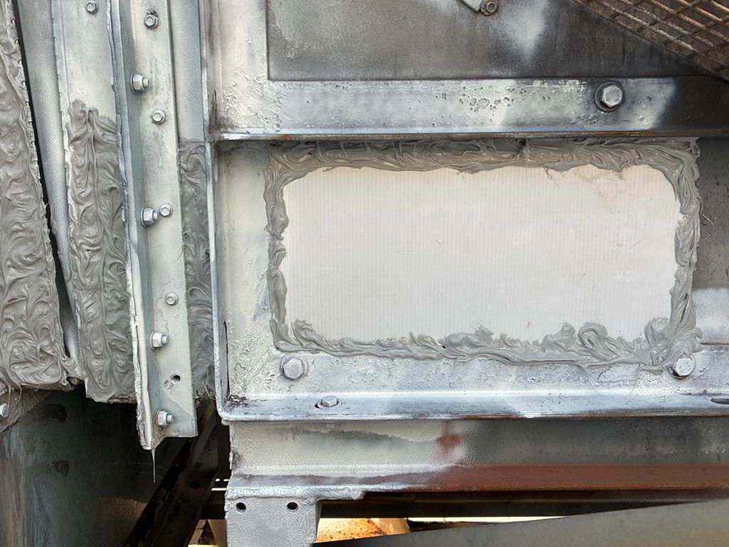 Cooling tower panel repaired and sealed to prevent corrosion.