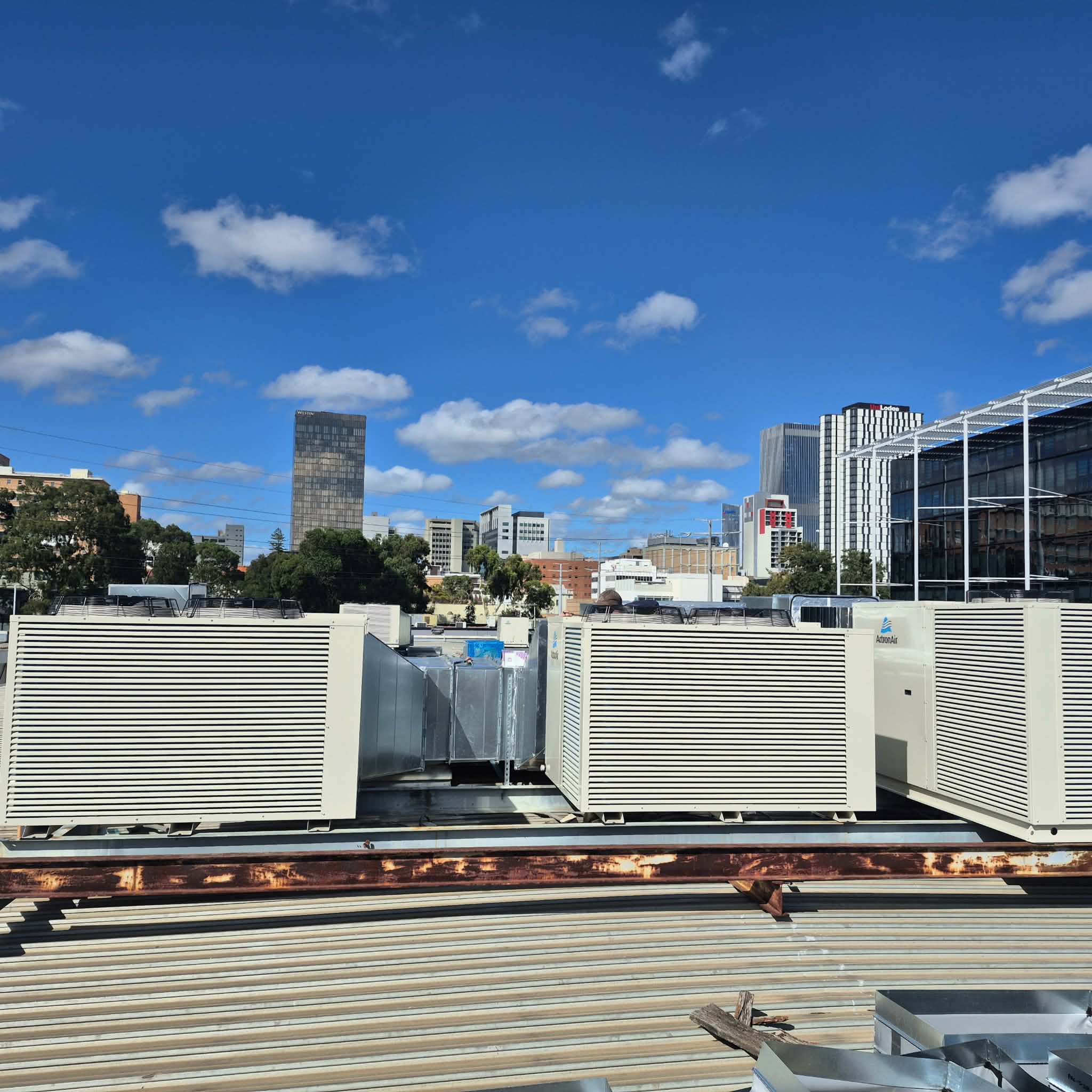 Multiple ActronAir rooftop HVAC units installed on a commercial building.